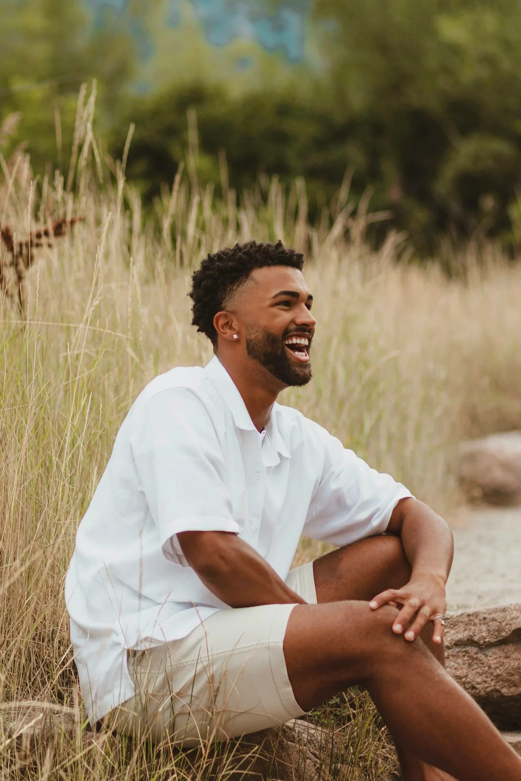 A man laughing joyfully outdoors — the renewed peace clients find after healing with WorthyMind Practice in Tarrytown, NY