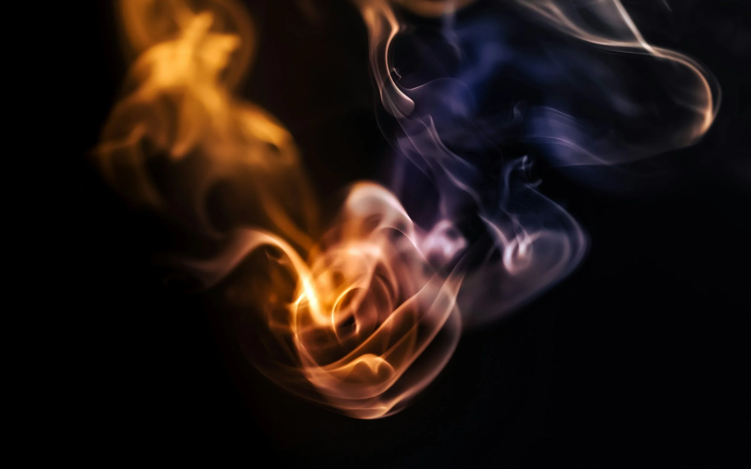 Orange flame and indigo smoke intertwining on a black backdrop — symbolizing the science-and-soul approach to integrative psychiatry at WorthyMind Practice