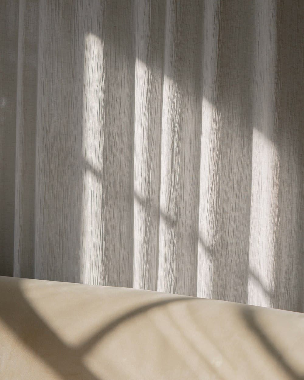 Soft daylight falling through a sheer linen curtain